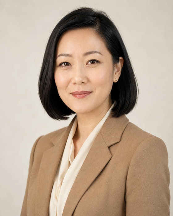 Mei Santoro, Partnerships Director for financial services, photographed against a pale studio background.
