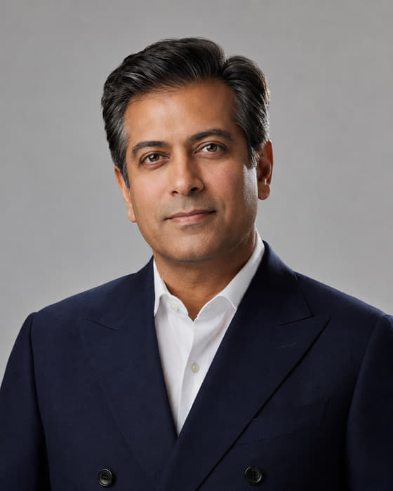 Samir Odell, Economics Editor of Montlior News, photographed against a plain grey studio background.